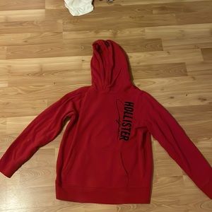 Hollister red hoodie with black text medium